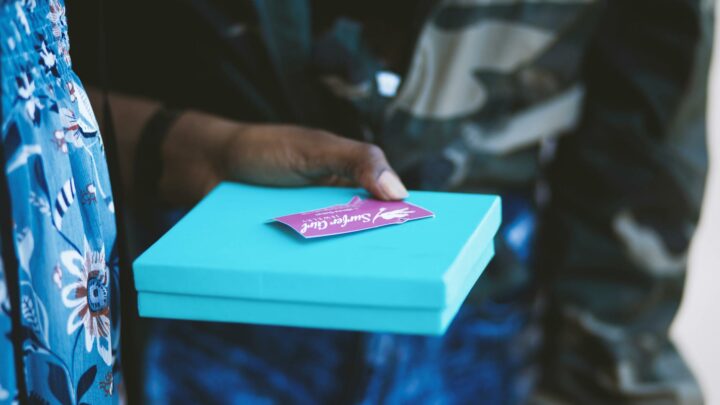person holding blue box
